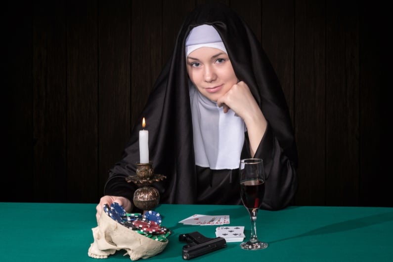 Conceptual portrait of a nun and gambling