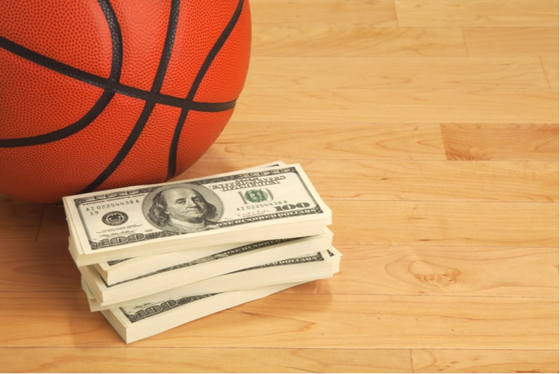 Stack of money with basketball