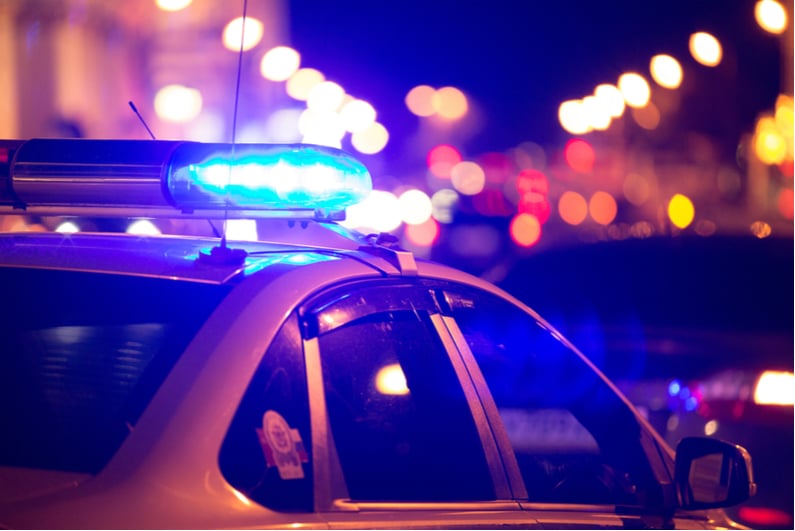 Flashing blue lights atop police cruiser