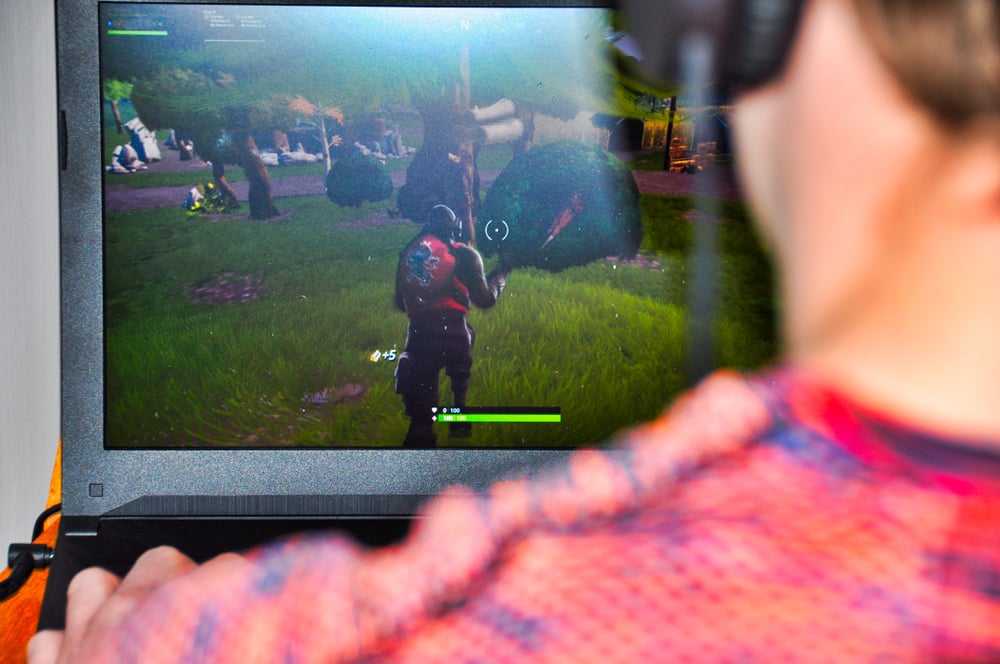 male-playing-fortnite-on-desktop-monitor