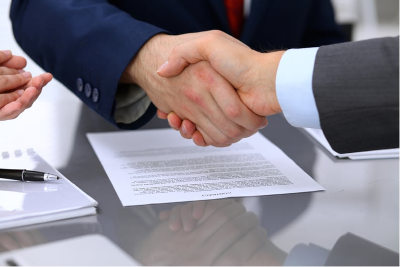 Businessmen shaking hands on a deal