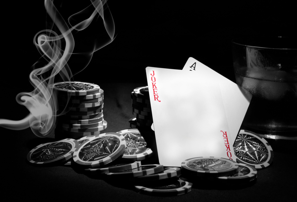 poker chips, cards, table and cigarette smoke