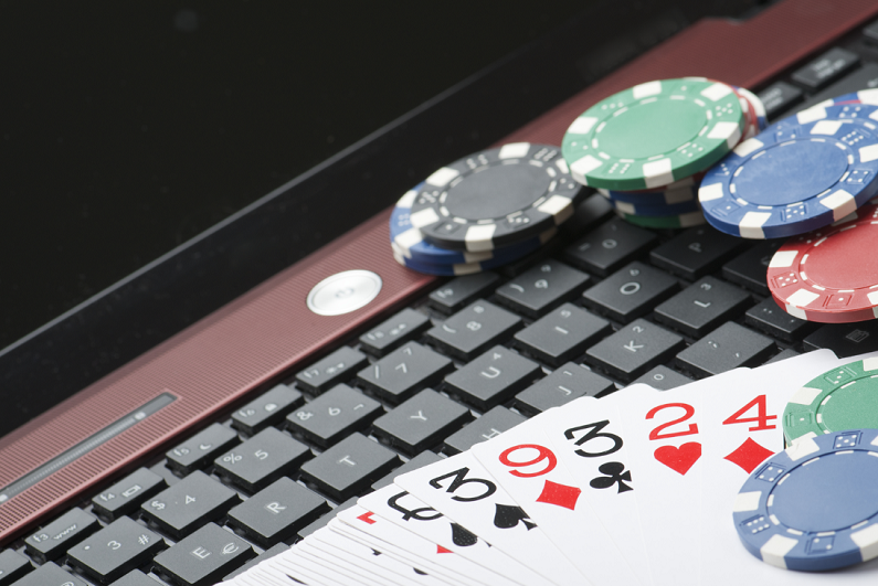 casino chips and cards on laptop