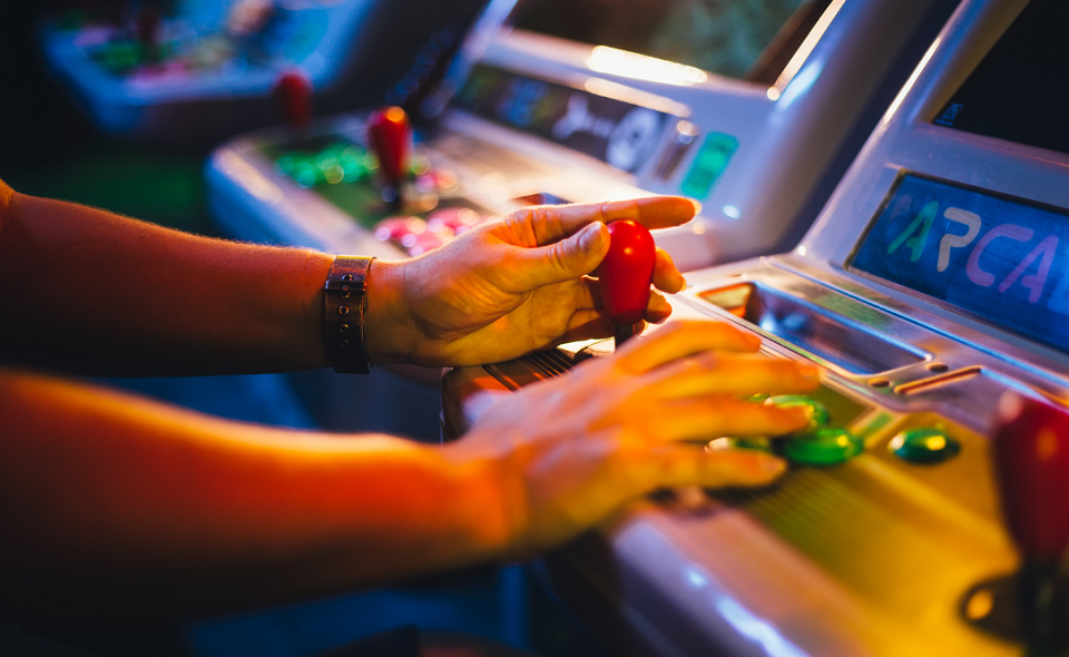 male playing arcade game