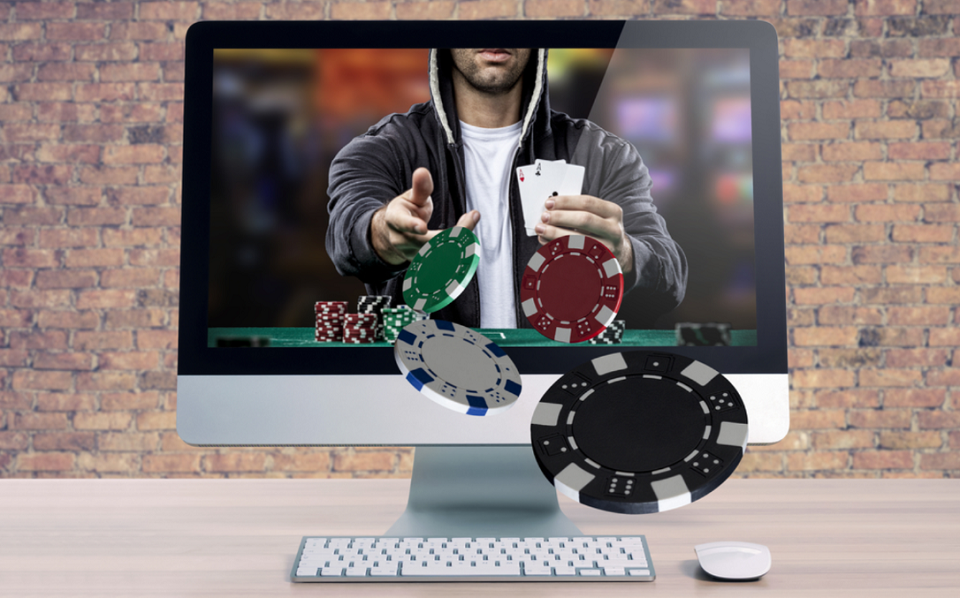 Online poker player with chips coming out of computer monitor