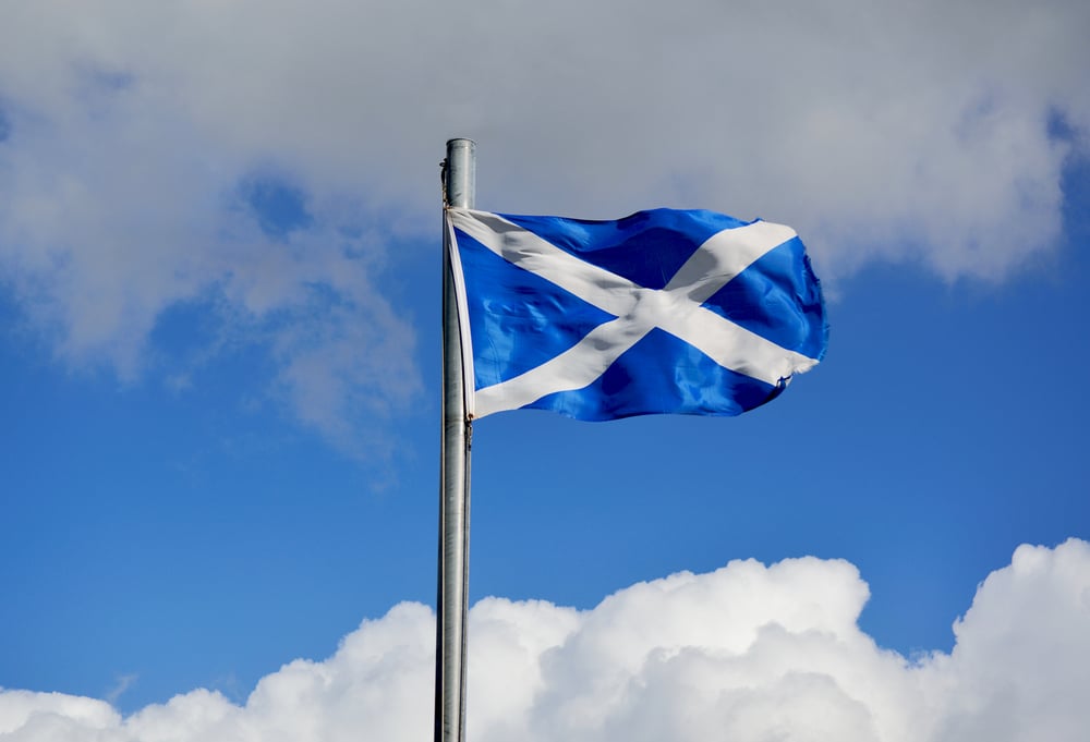 flag of Scotland against bright blue sky background