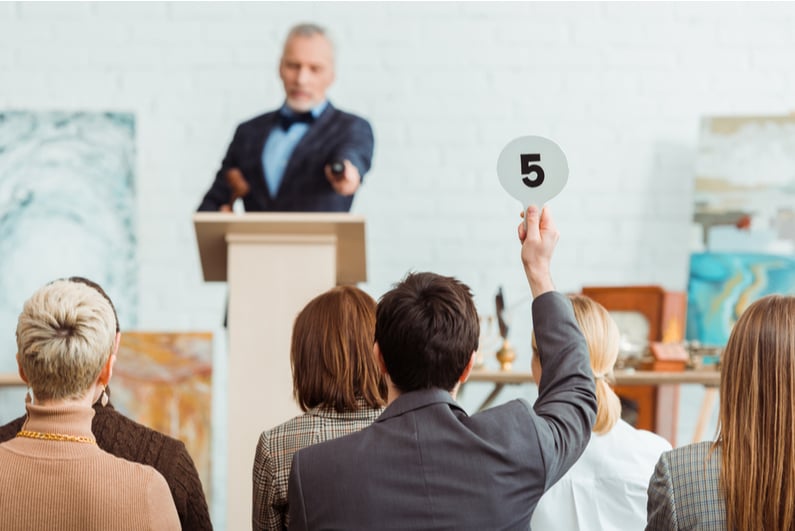 Auctioneer pointing at a bidder