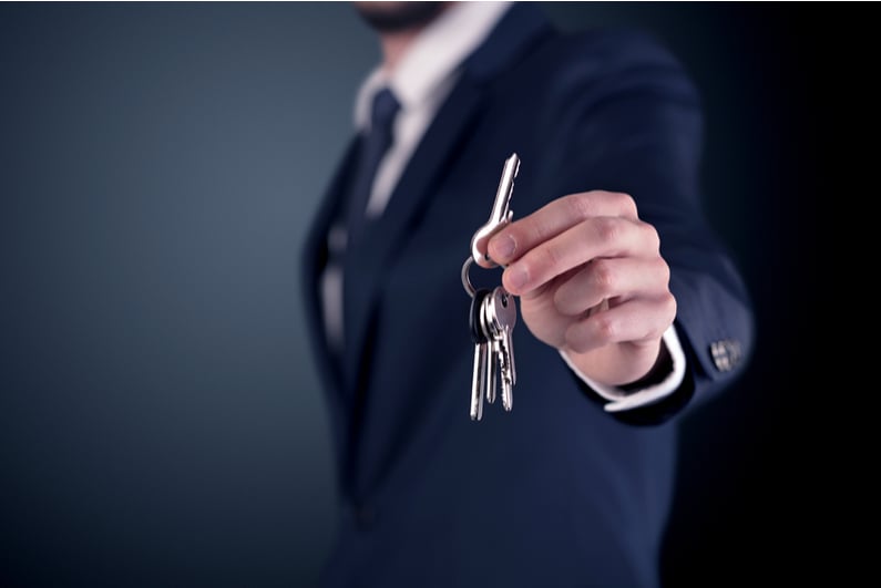 businessman handing over car keys