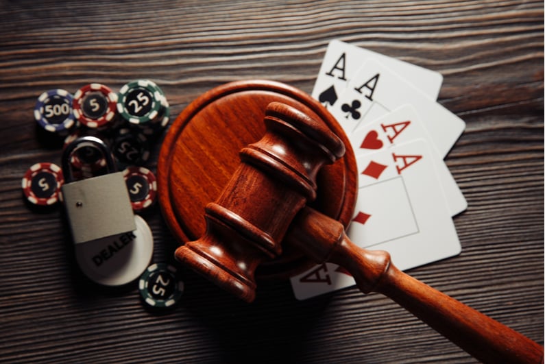 Judge's gavel, playing cards, and poker chips