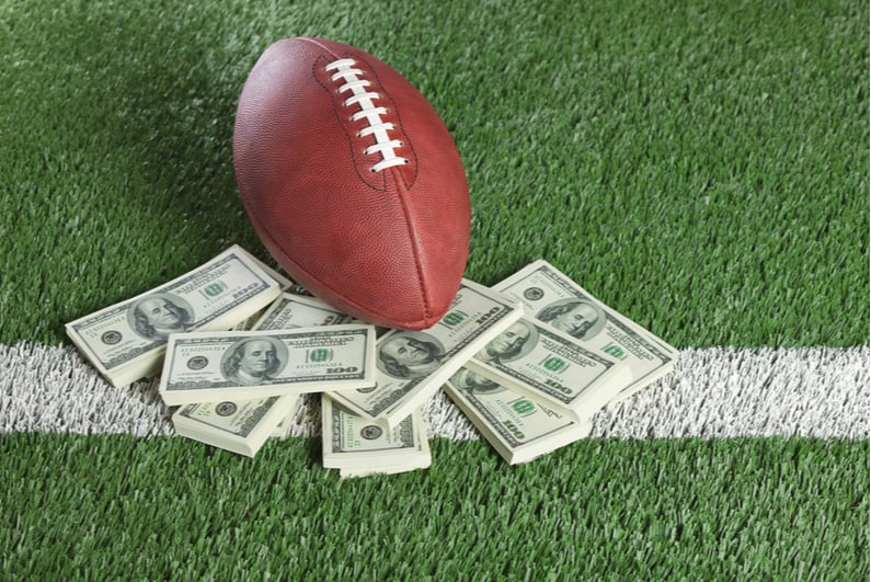 American football with US bank notes